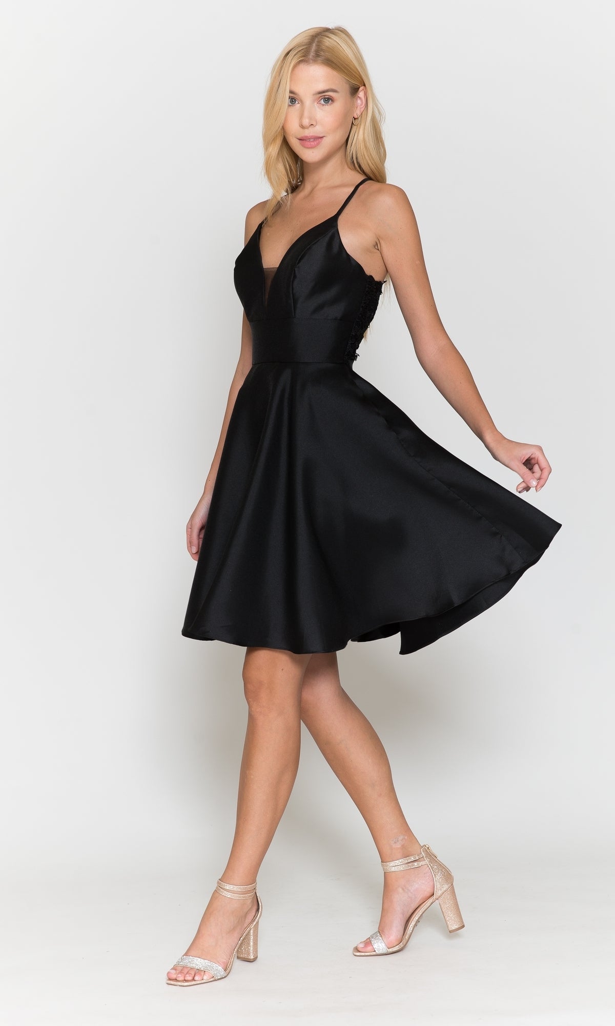 A woman models the Lace-Back Short A-Line Homecoming Dress 8698 with heeled sandals against a plain white background.